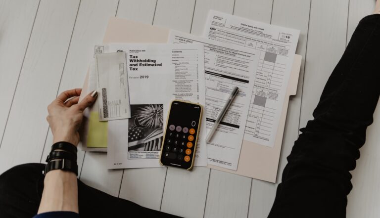 Calculator and financial documents on a desk, representing loan management and lending operations