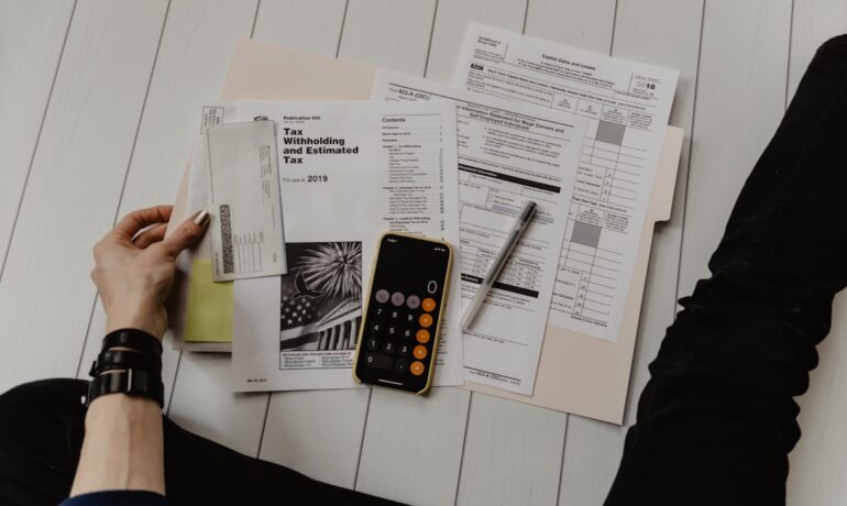 Calculator and financial documents on a desk, representing loan management and lending operations